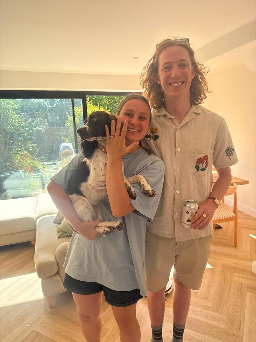 Hannah and Owain celebrating their engagement at home with their dog